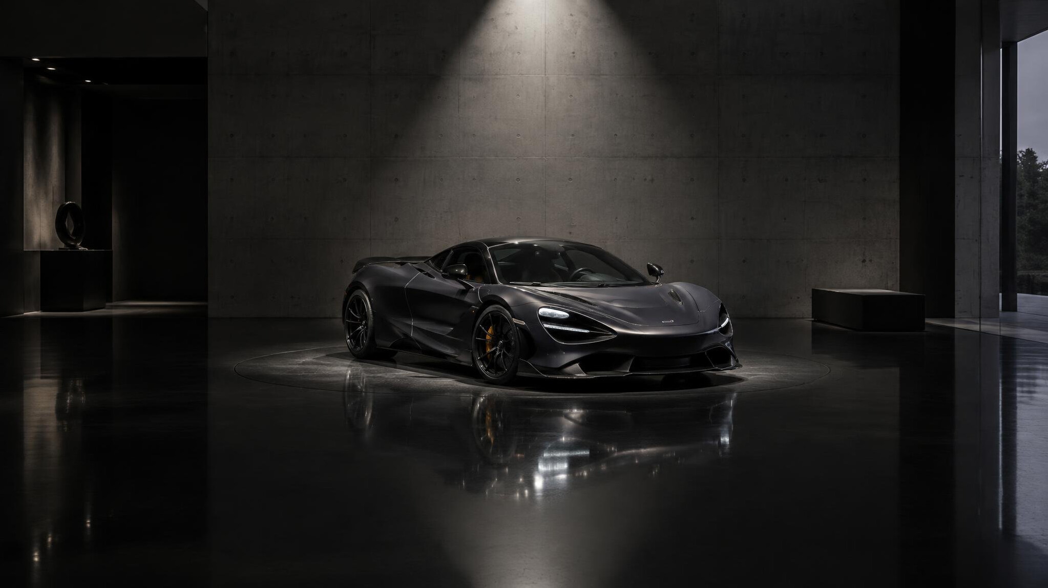 Minimalist showroom interior displaying a single exotic sports car under a spotlight